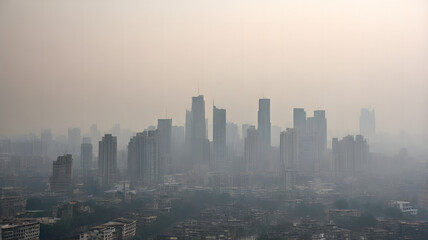 Fototapeta premium a city skyline shrouded in thick smog, with only the outlines of tall buildings visible through the haze, highlighting the severity of urban air pollution