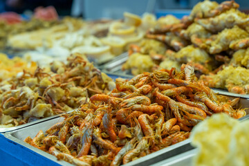 The photo showcases a mouthwatering grilled squid, cooked to perfection over an open flame. The golden-brown exterior glistens under the smoky aroma of the barbecue