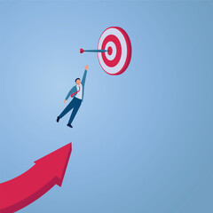 A man jumps from an arrow towards a target stuck with a dart, an illustration of achieving a goal.