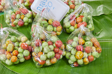 Fresh tomatoes in plastic bag for sale at market