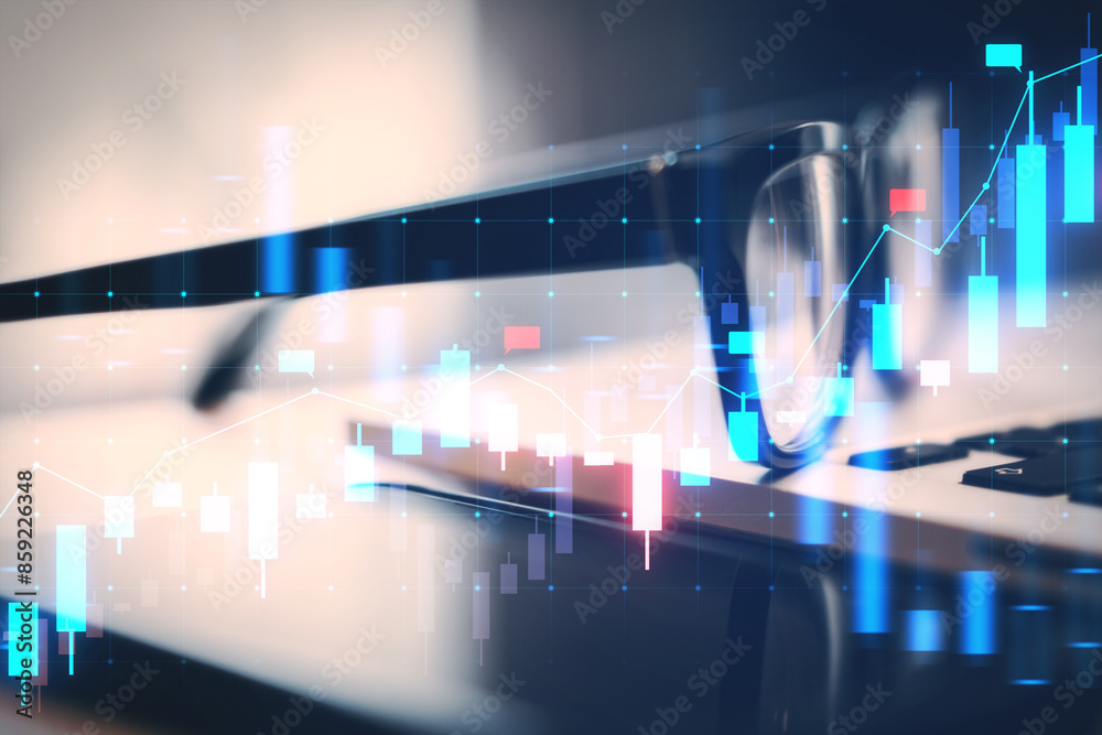 Poster eyeglasses over a laptop keyboard with a double exposure of financial graphs, illustrating a busines