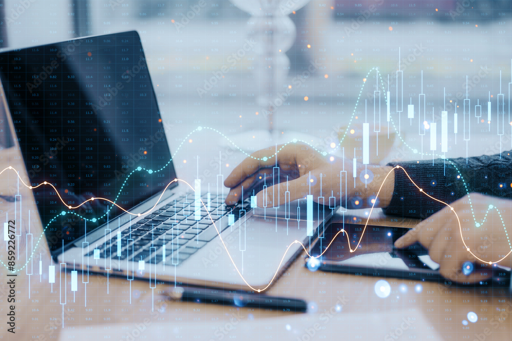 Poster hands typing on a laptop with financial graphs overlaying the image, set on a desk, concept of busin