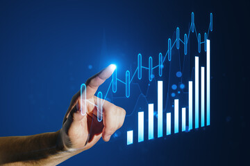 A hand interacting with glowing digital graphs on a blue background, symbolizing business analytics...