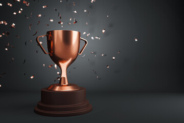 A bronze trophy cup with confetti on a dark background, symbolizing celebration of victory or...