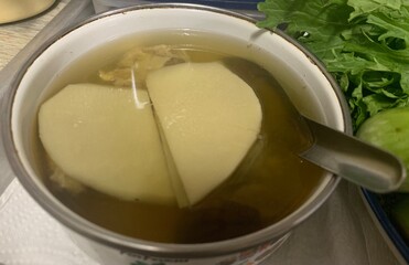 clear soup with pieces of bamboo shoot bowl isolated on white, bowl of pork bone broth soup with vegetables and rice isolated on white background