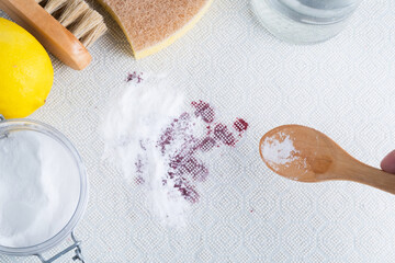 Fruit or blood stains on blue cloth. Ecological method of stain removing a fabric sofa or rug with baking soda. Embracing a zero-waste lifestyle. dirty stains in daily life. 