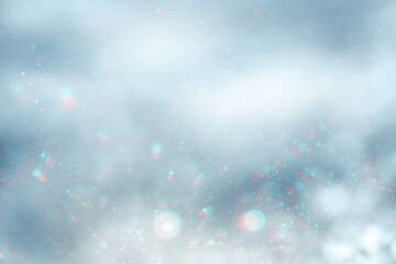 abstract soft gray background with sparkling particles of white, pink and blue shades. copy space