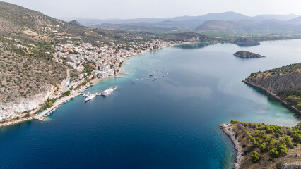 Aerial drone photo of famous seaside village small port and long sandy beach of Tolo with hotels and resorts built by the sea, Argolida, Peloponnese, Greece