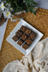 Kuih kole kacang, a steamed Malaysian cake, made with fried green bean flour, coconut milk, and palm sugar.  The decoration of the cake is from coconut oil grease or residue. Selective focus.