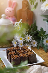 Kuih kole kacang, a steamed Malaysian cake, made with fried green bean flour, coconut milk, and palm sugar.  The decoration of the cake is from coconut oil grease or residue. Selective focus.