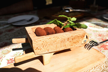 Chocolate candies on a wooden plate.