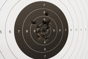 Paper target for shooting and bullet holes. © Dmitri