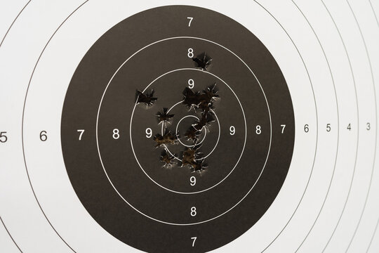 Paper target for shooting and bullet holes.