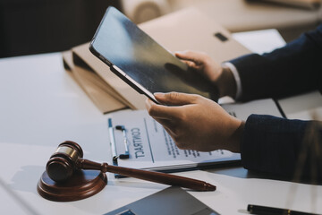 Male lawyer working with contract papers and wooden gavel on tabel in courtroom. justice and law ,attorney, court judge, concept.