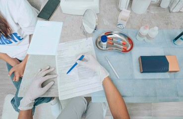 healthcare worker meticulously filling out a patient form, representing the precision and attention...