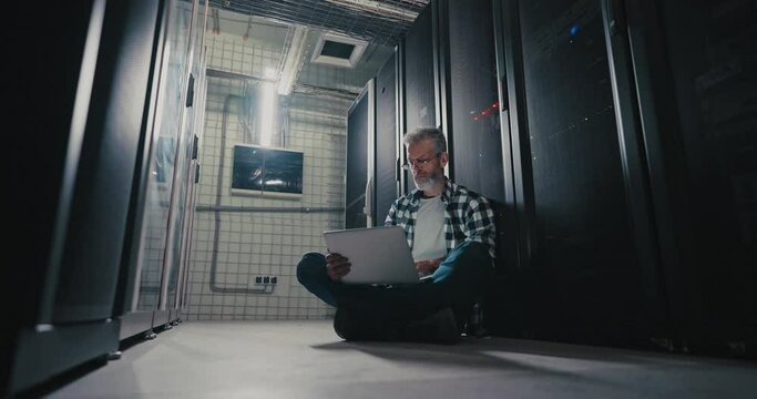 Man Sitting on Floor in Server Room