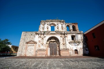 Fototapeta premium wide capture of antique facade in south american colonial town with the moon framed in middle of window