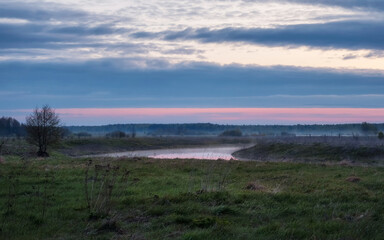 Bend of the river in the early foggy morning.