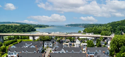 Fotobehang New York drone image of Roslyn New York, Northern Blvd and Hempstead Bay with blue sky and puffy clouds.  © Aurora East Media