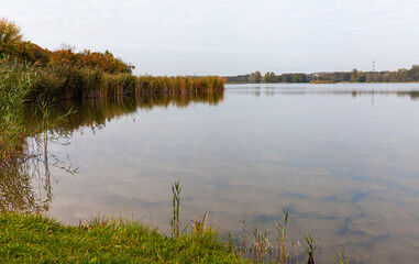 Landscape in the countryside by the lake on a sunny October day. A quiet place to relax by the water.