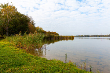 Landscape in the countryside by the lake on a sunny October day. A quiet place to relax by the water.
