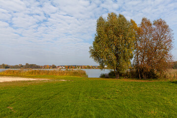 Landscape in the countryside by the lake on a sunny October day. A quiet place to relax by the water.