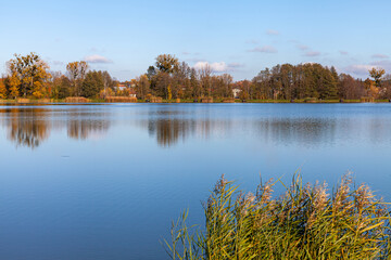 Landscape in the countryside by the lake on a sunny October day. A quiet place to relax by the water.