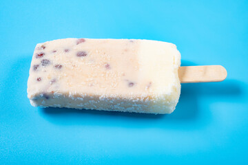 angle view milkshake flavor popsicle with red beans on blue background