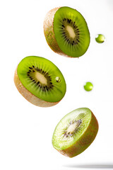 Fototapeta premium Slices of kiwi falling, isolated white background