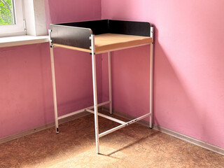 Baby changing table near the pink wall in the clinic