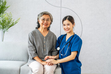Young asian female doctor or nurse happily supports elderly patients. Doctor and senior grandmother...