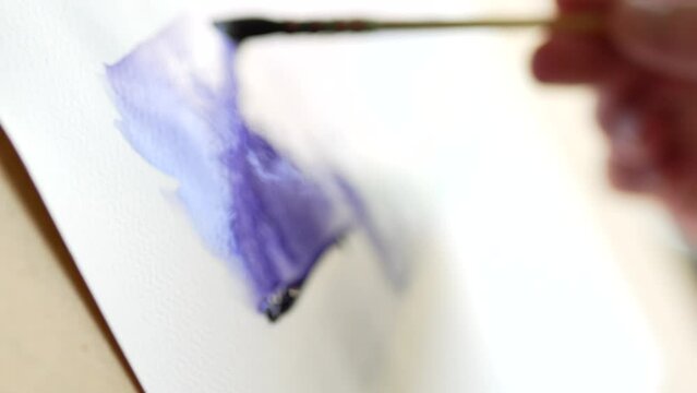 Man paints with watercolor paintings. Artist concept video.