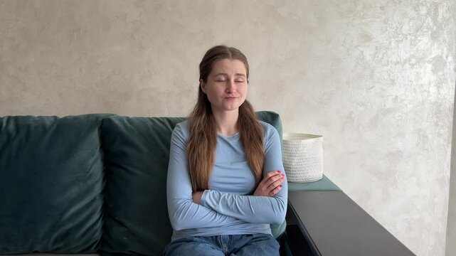 Woman on couch displays a range of emotions, from neutral to smiling, then thoughtful and pouting. Perfect for showing emotional variability