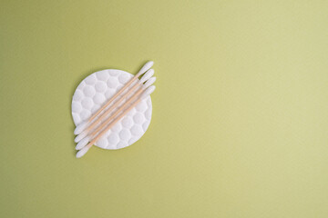 Bamboo cotton buds and cotton pads on a colored background. Biodegradable ear plugs. Eco product