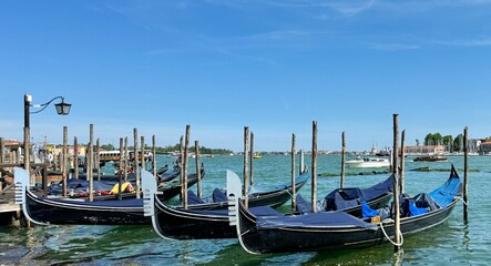 Beautiful blue gondolas parked at dock in Venice, Italy  © bleung