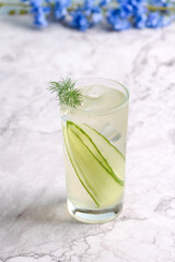 Cucumber lemonade with natrual ice cubes garnished with dill.