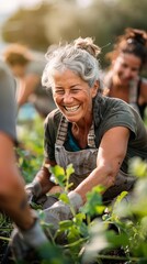 Fototapeta premium Smiling woman gardening with other people in the background.