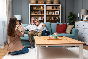 Simple living Mother father and daughter enjoying lovely time together at home. Senior couple and...