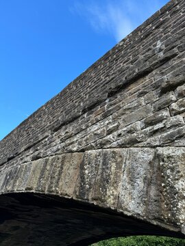Stone bridge arch over water