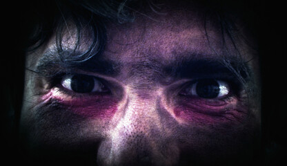 Halloween or horror themed shot of crazy eyes looking around and in camera. Eyes come very close to...