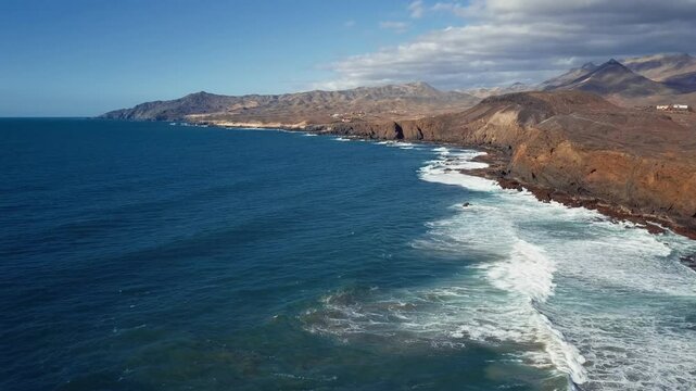Aerial view of desert Fuerteventura coastline near Costa Calma, Pajara: Punta de Guadalupe, La Pared, Fuerteventura, Canary Islands. 2.5x speeded up from 24 fps.