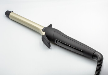 Hair curling iron for professional styling closeup on white.