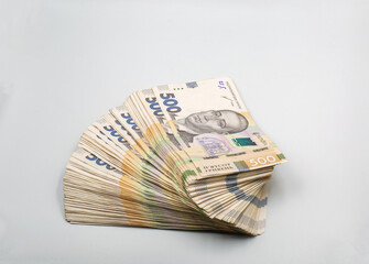 Ukrainian hryvna currency notes heap closeup on white.