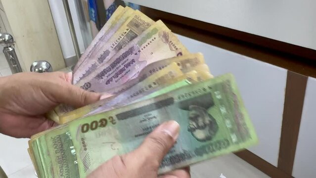 Bangladeshi Man counting Bangladeshi Currency Note Taka. BDT currency of Bangladesh. 