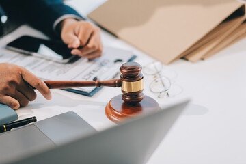 Male lawyer working with contract papers and wooden gavel on tabel in courtroom. justice and law ,attorney, court judge, concept.