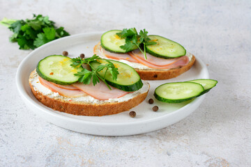 a plate of sandwiches with ham, cheese, turmeric and cucumber  