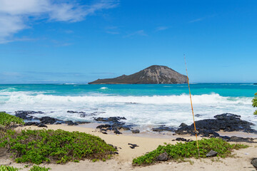 Beautiful beach with a distant island under sunny sky