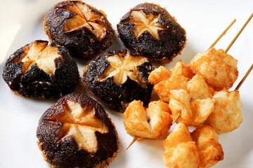 Close-up of fried mushrooms and squid balls on a plate