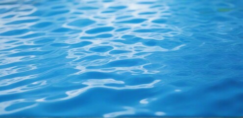 Fototapeta premium Sun reflecting on the beautiful blue water surface of a swimming pool