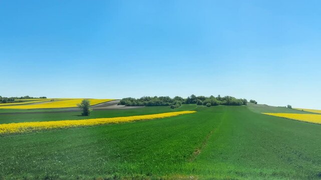 View from the train window on agricultural fields in Poland in spring.